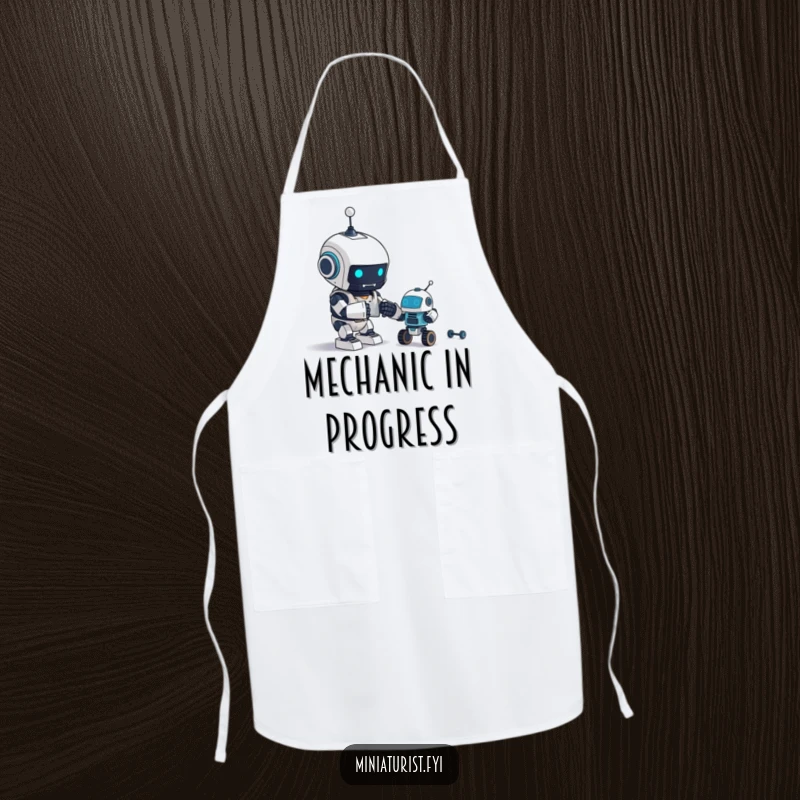 Funny Apron: A tiny robot excitedly assembles an even tinier robot, fitting for any creator in the kitchen.