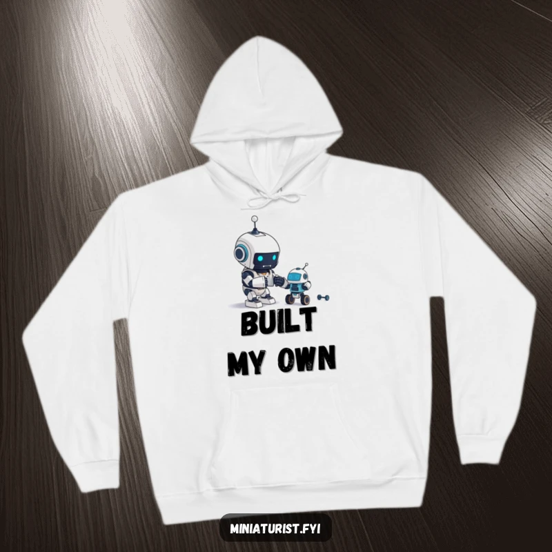 Funny Hoodie: A tiny robot is engrossed in assembling an even tinier robot, radiating excitement.
