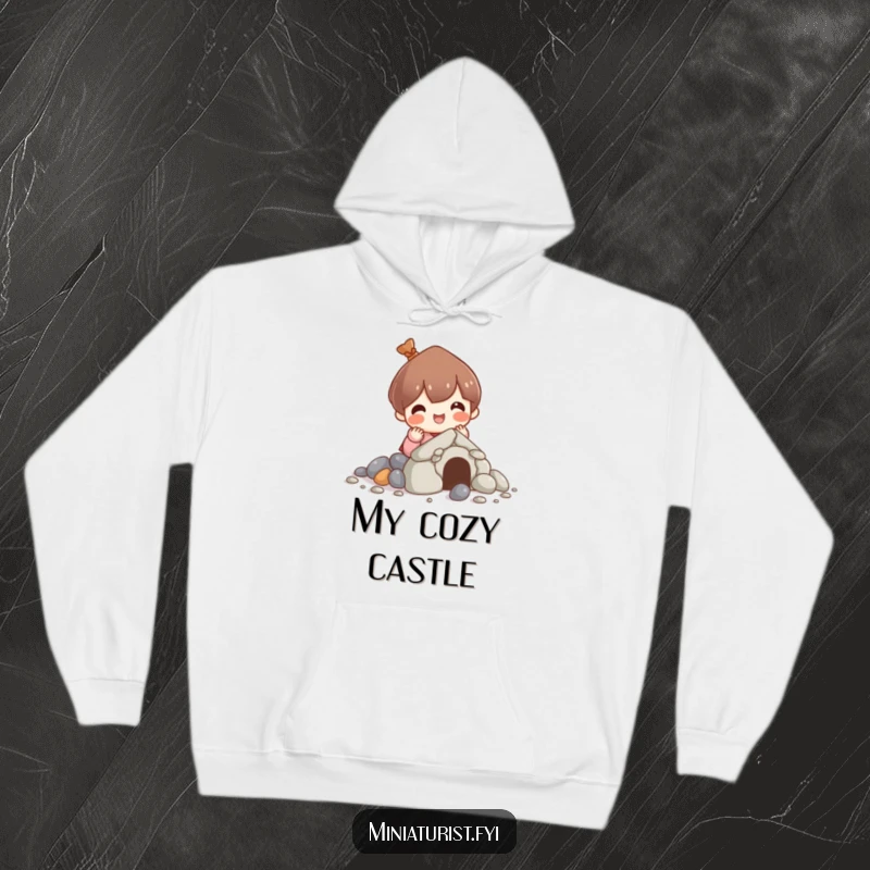 Funny hoodie depicting a character cheerfully building a house out of pebbles, symbolizing cozy construction and imaginative building projects.