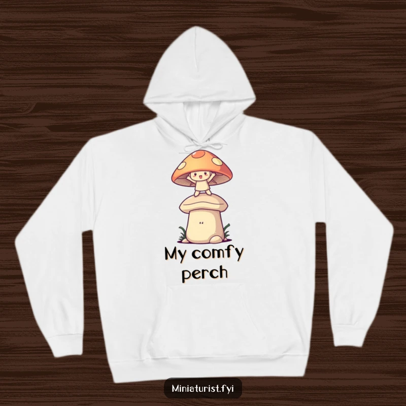 Funny hoodie with a small character balancing with arms out on a large mushroom cap, showcasing delightful whimsy and joy.