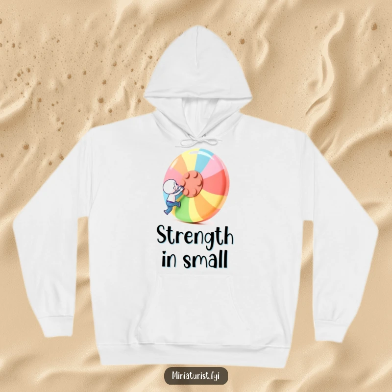 Funny Hoodie: A tiny character attempts to lift a giant colorful button, demonstrating strength and determination.