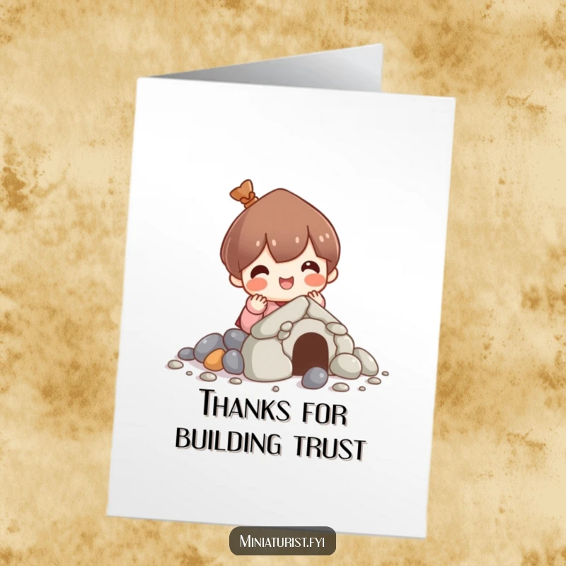 Funny free printable thank you card: a cute character concentrates on building a small house using only pebbles, a sweet gesture.